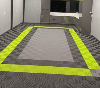 Gray garage floor with a bright lime tile border